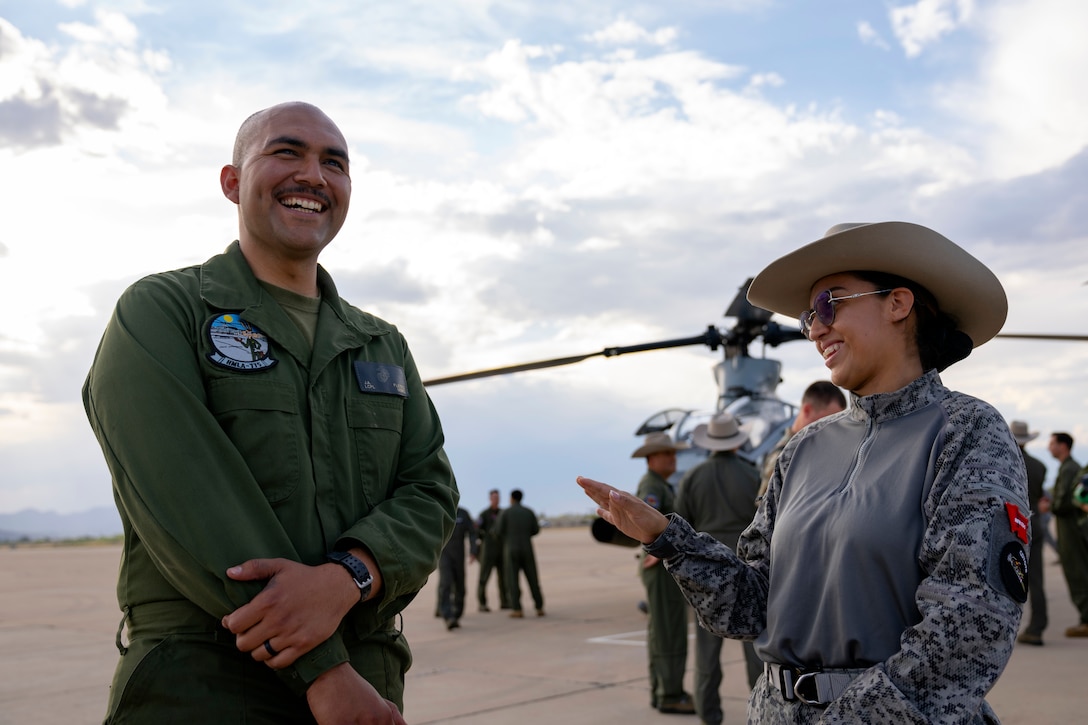 A U.S. Marine and Colombian Air Force technician share a lighthearted moment during an exchange between Red Flag-Rescue 23-1 exercise participants at Davis-Monthan Air Force Base, Ariz., May 16, 2023. The multilateral combat search and rescue exercise is designed to enhance interoperability with joint-services alongside allied and partner nations. (U.S. Air Force Photo by Tech. Sgt. Rachel Maxwell)