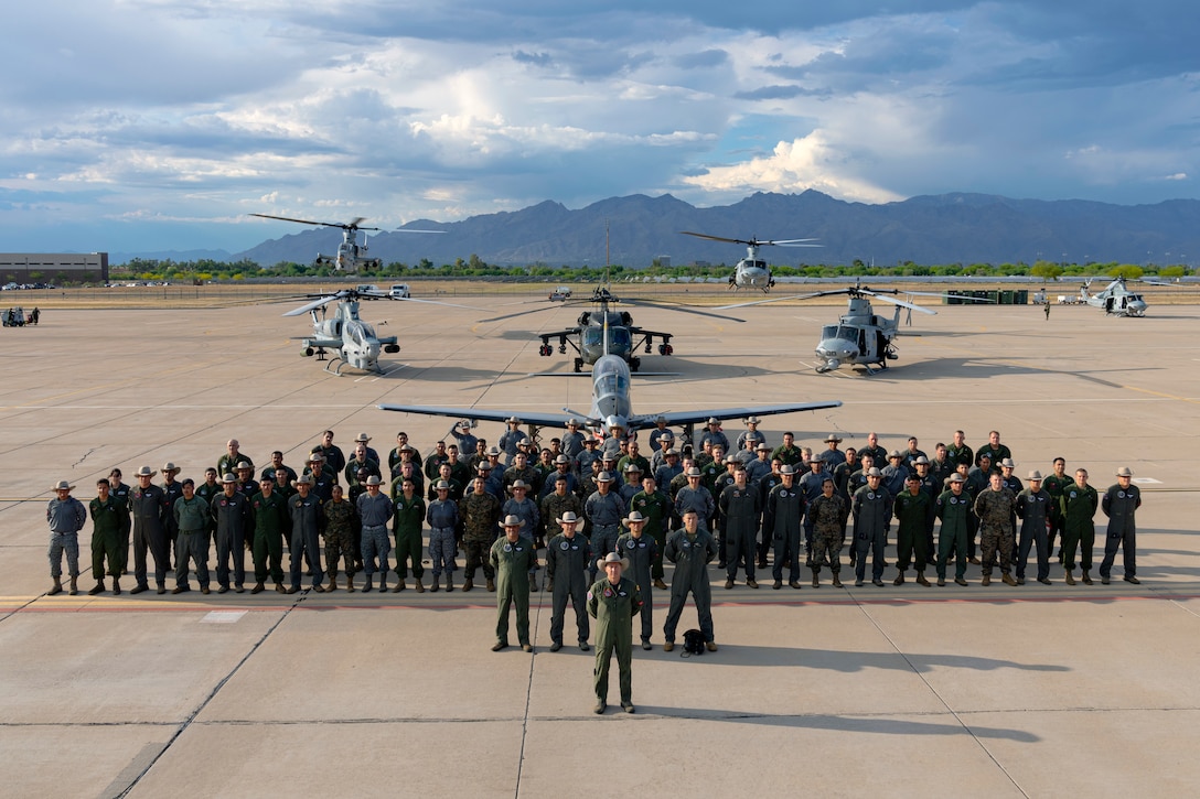 U.S. Marine Corps and Colombian Air Force Red Flag-Rescue 23-1 exercise participants gather for a group photo at Davis-Monthan Air Force Base, Ariz., May 16, 2023. Joint forces build combat search and rescue proficiency through combined multilateral exercises, such as Red Flag-Rescue, aimed at strengthening partnerships, enhancing interoperability, and training to save lives in a multifaceted domain. (U.S. Air Force Photo by Tech. Sgt. Rachel Maxwell)