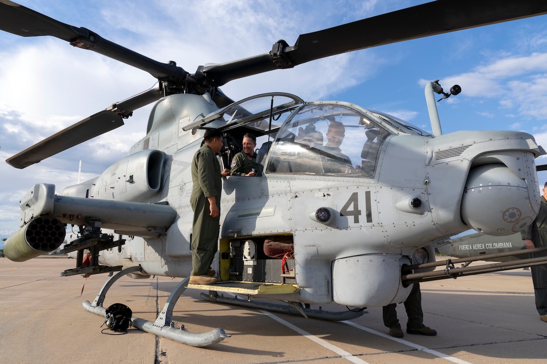 Colombian Air Force Brig. Gen. Alejandro Vélez, Combat Air Command No. 2 commander, sits in backseat of a U.S. Marine Corps AH-1Z Viper helicopter during an exchange with Red Flag-Rescue 23-1 exercise participants at Davis-Monthan Air Force Base, Ariz., May 16, 2023. Exercises like Red Flag-Rescue present opportunities to build regional capacity with partner nations by enhancing cooperation, collaboration, and interoperability in a joint environment. (U.S. Air Force Photo by Tech. Sgt. Rachel Maxwell)