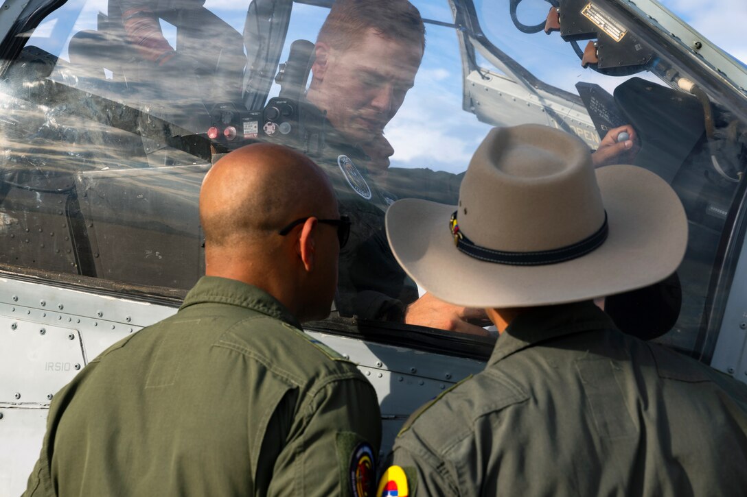 Colombian Air Force aircrew members inspect the cockpit of a U.S. Marine Corps AH-1Z Viper helicopter during an exchange with Red Flag-Rescue 23-1 exercise participants at Davis-Monthan Air Force Base, Ariz., May 16, 2023. The multilateral combat search and rescue exercise is designed to enhance interoperability with joint-services alongside allied and partner nations. (U.S. Air Force Photo by Tech. Sgt. Rachel Maxwell)