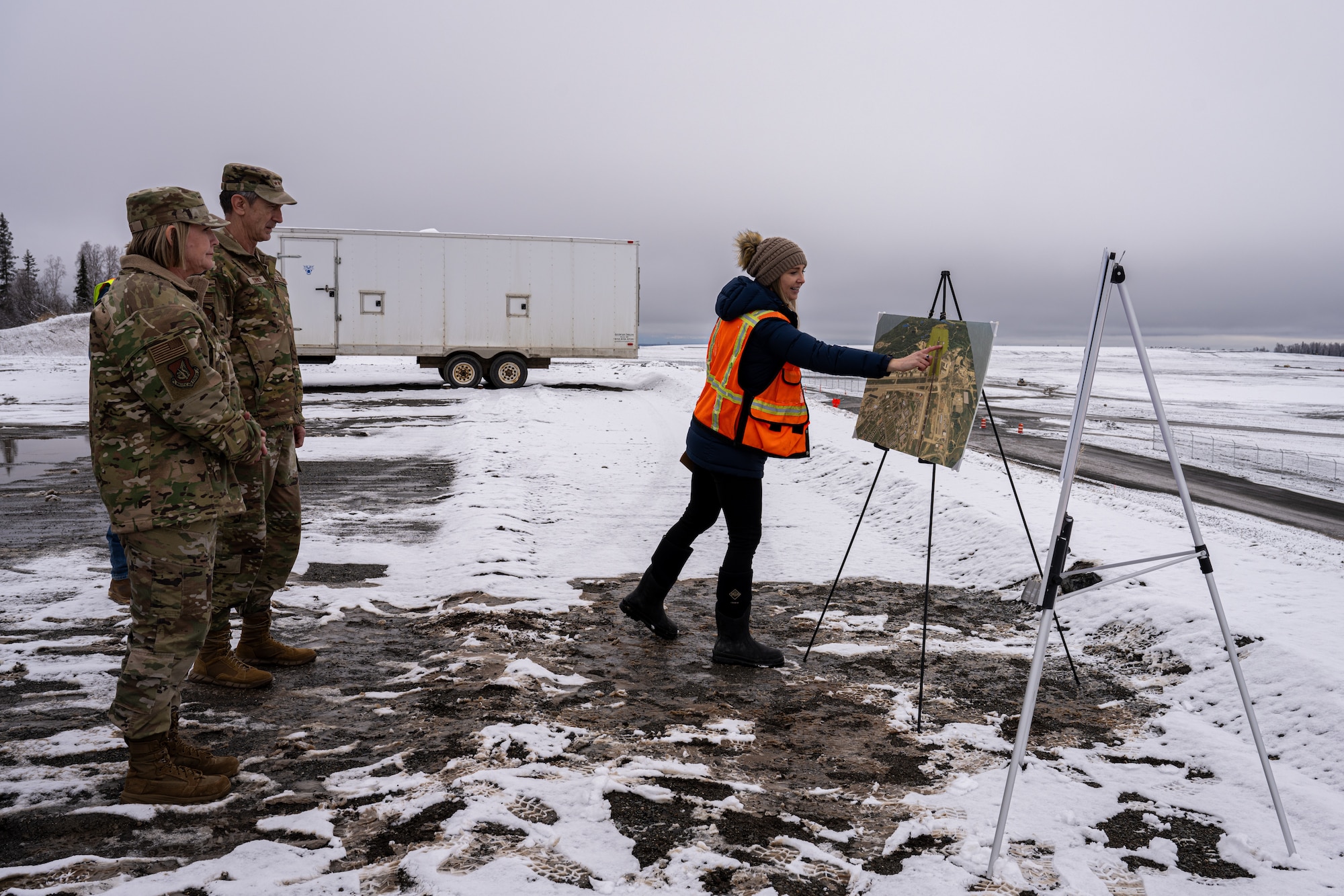 From left: U.S. Air Force Chief Master Sgt. Katie McCool, PACAF command chief master sergeant; Gen. Kevin Schneider, Pacific Air Forces commander; and Elizabeth Madison, 673d Civil Engineer Squadron; discuss the plans for extending the flightline and enhancing the installation at Joint Base Elmendorf-Richardson, Alaska, April 10.