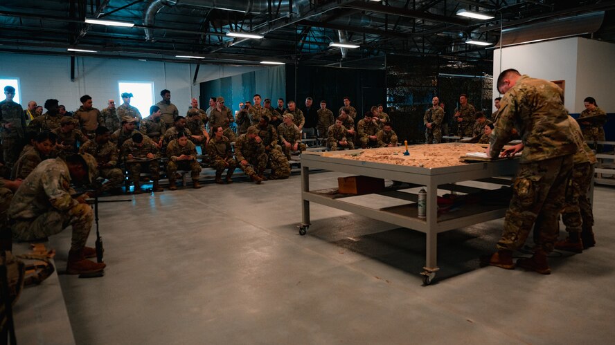 91st Missile Security Operations Squadron Convoy Response Force defenders review tactics and procedures before heading to the North Training Area during the Nuclear Convoy Course at Camp Guernsey Joint Training Center, Wyoming, April 7, 2025. The course brings together CRF teams and helicopter crews from across 20th Air Force to rehearse integrated responses in a realistic joint training environment. (U.S. Air Force photo by Staff Sgt. Michael A. Richmond)