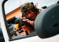 A 91st Missile Security Operations Squadron defender conducts vehicle egress training at Camp Guernsey Joint Training Center’s North Training Area, Wyoming, April 8, 2025. The drill simulates a hostile engagement scenario requiring defenders to rapidly exit their vehicle, establish security, and engage potential threats while coordinating with convoy elements. (U.S. Air Force photo by Staff Sgt. Michael A. Richmond)
