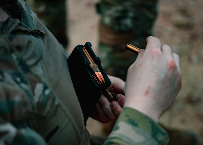 A 91st Missile Security Operations Squadron defender loads a magazine with 7.62mm rounds during a live-fire exercise at Camp Guernsey Joint Training Center’s North Training Area, Wyoming, April 8, 2025. Live-fire exercises reinforce weapons proficiency and convoy defense readiness for Airmen charged with securing nuclear assets. (U.S. Air Force photo by Staff Sgt. Michael A. Richmond)