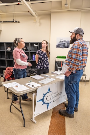 Heidi Anderson, and Patricia Leiataua, both career counselors, Command Career Center, speak with Cody Vandersluis, maintenance mechanic, Shop 06, Tooling and Maintenance, about career advancement, April 9, 2025, during a “pop-up” knowledge share event at Puget Sound Naval Shipyard & Intermediate Maintenance Facility in Bremerton, Washington. (U.S Navy photo by Jeb Fach)