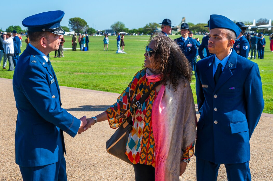 U.S. Air Force Col. Sergio Anaya, 62d Airlift Wing commander, greets a Basic Military Training graduate’s loved one following the graduation parade at Joint Base San Antonio-Lackland, Texas, April 10, 2025.