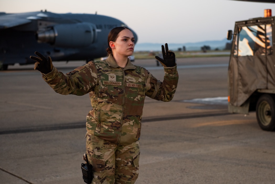 Airman directing forklift on flight line