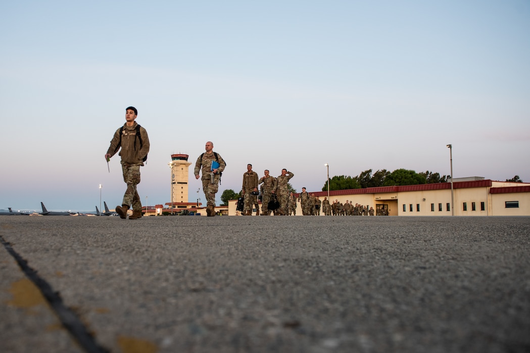 Airmen walking toward aircraft on flight line