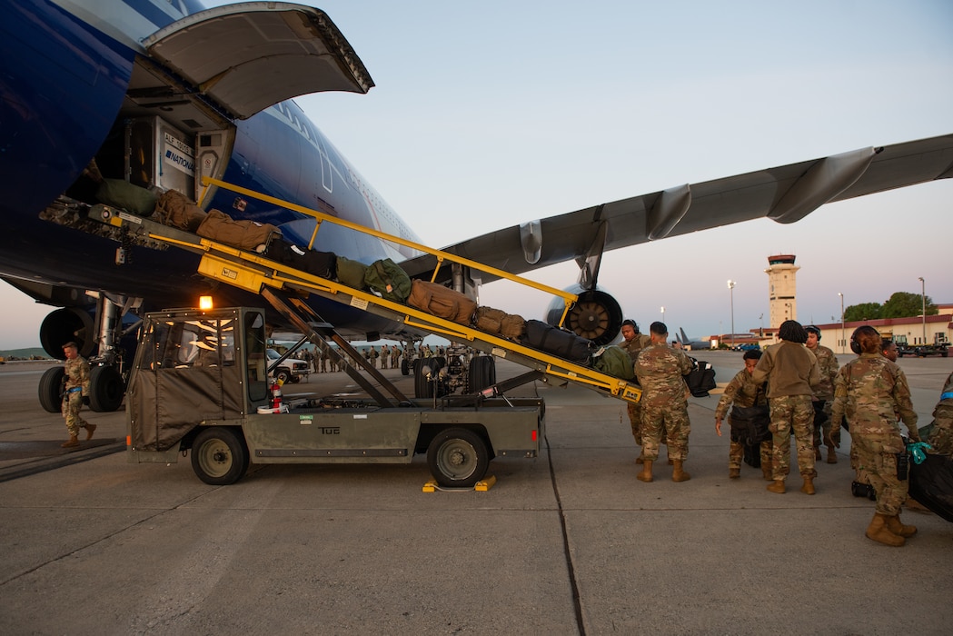 Airmen load cargo onto aircraft
