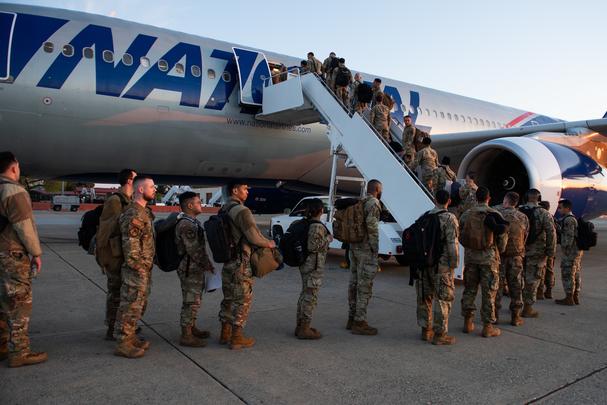 Airmen load onto commercial aircraft on flight line