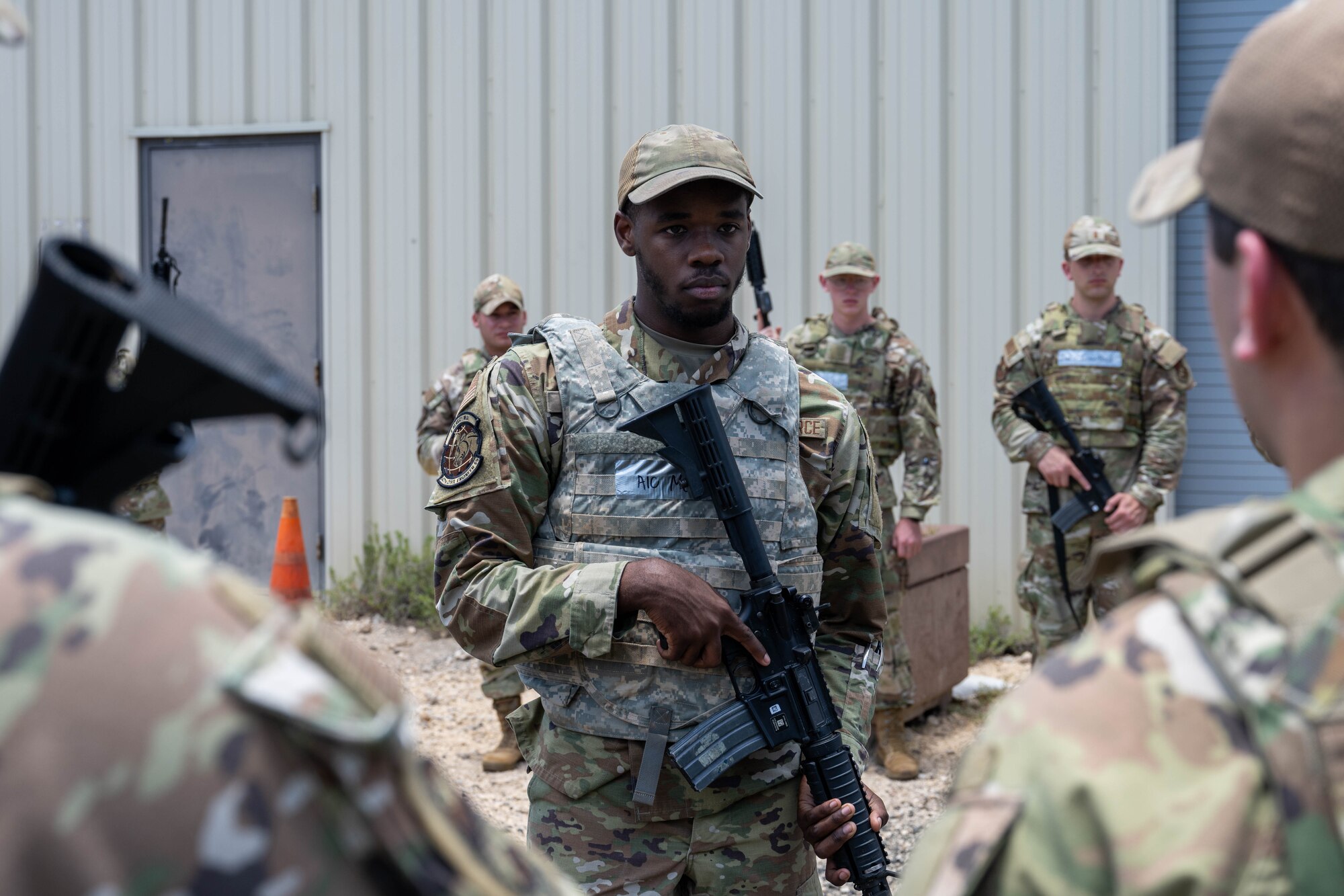 A U.S. Air Force Airmen leads and listens to his team during a patrol training exercise.