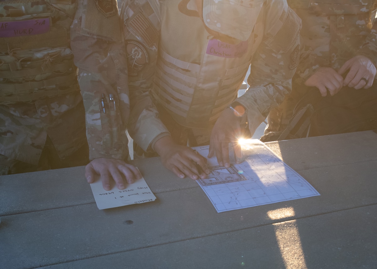 Airmen from the 22nd Civil Engineer Squadron map out coordinates during the 22nd CES Battle of the Bulls competition at McConnell Air Force Base, Kansas, April 17, 2025. Teams started the event by mapping their routes to different stations as part of the competition. (U.S. Air Force photo by Senior Airman Amelio Brown)