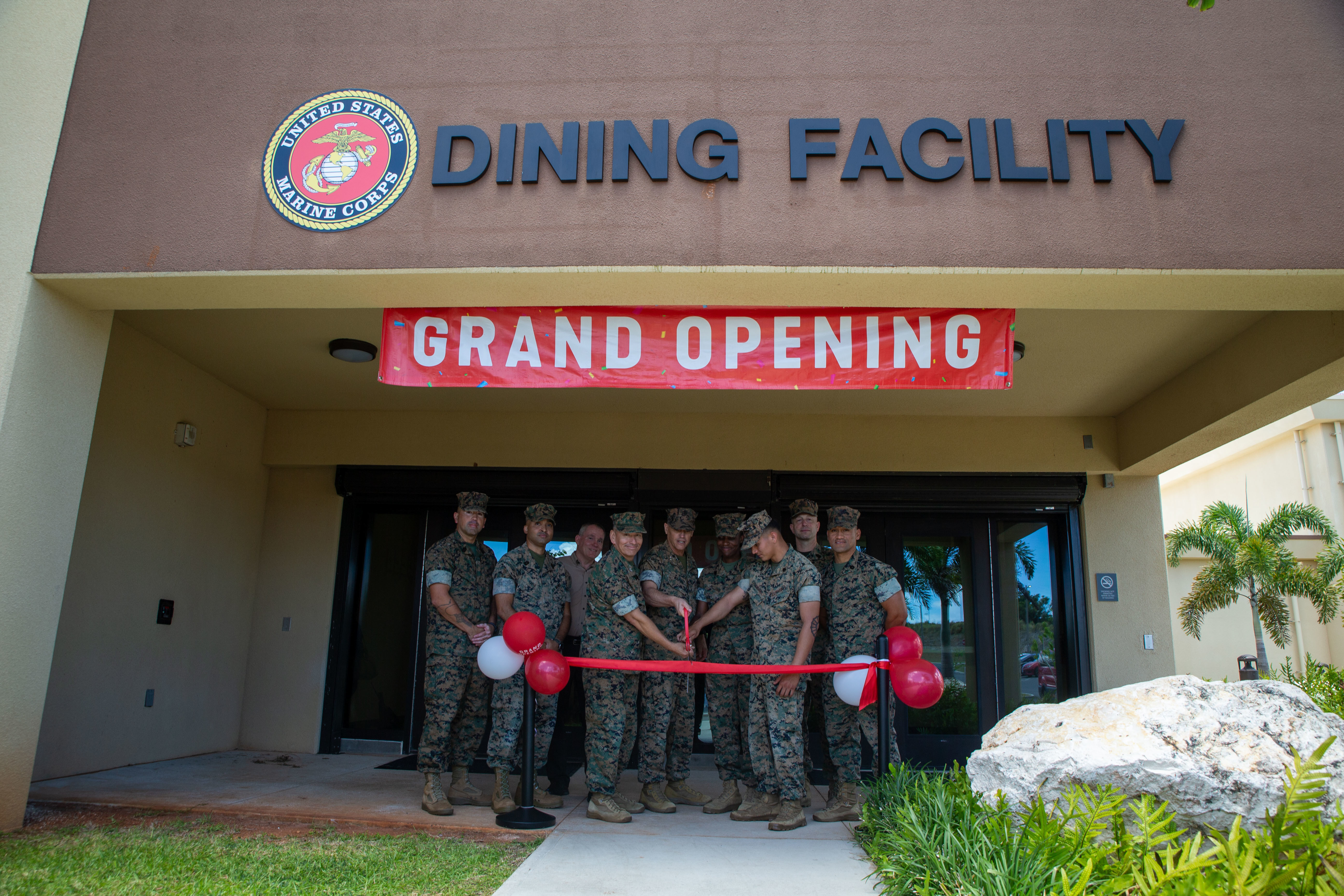 U.S. Marines with Marine Corps Base Camp Blaz hold a ribbon cutting ceremony for the grand opening of the first Camp Blaz-owned chow hall on Andersen Air Force Base, Guam, April 24, 2025. The food service Marines with MCB Camp Blaz and civilian workforce personnel played a key role in establishing the very first Camp Blaz-owned chow hall by developing the menu, setting hours of operation, and implementing procedures necessary for successful operations. This event marks a major milestone for Camp Blaz as one of the first of many completed facilities in the ongoing base development. (U.S. Marine Corps photo by Lance Cpl. Afton Smiley)