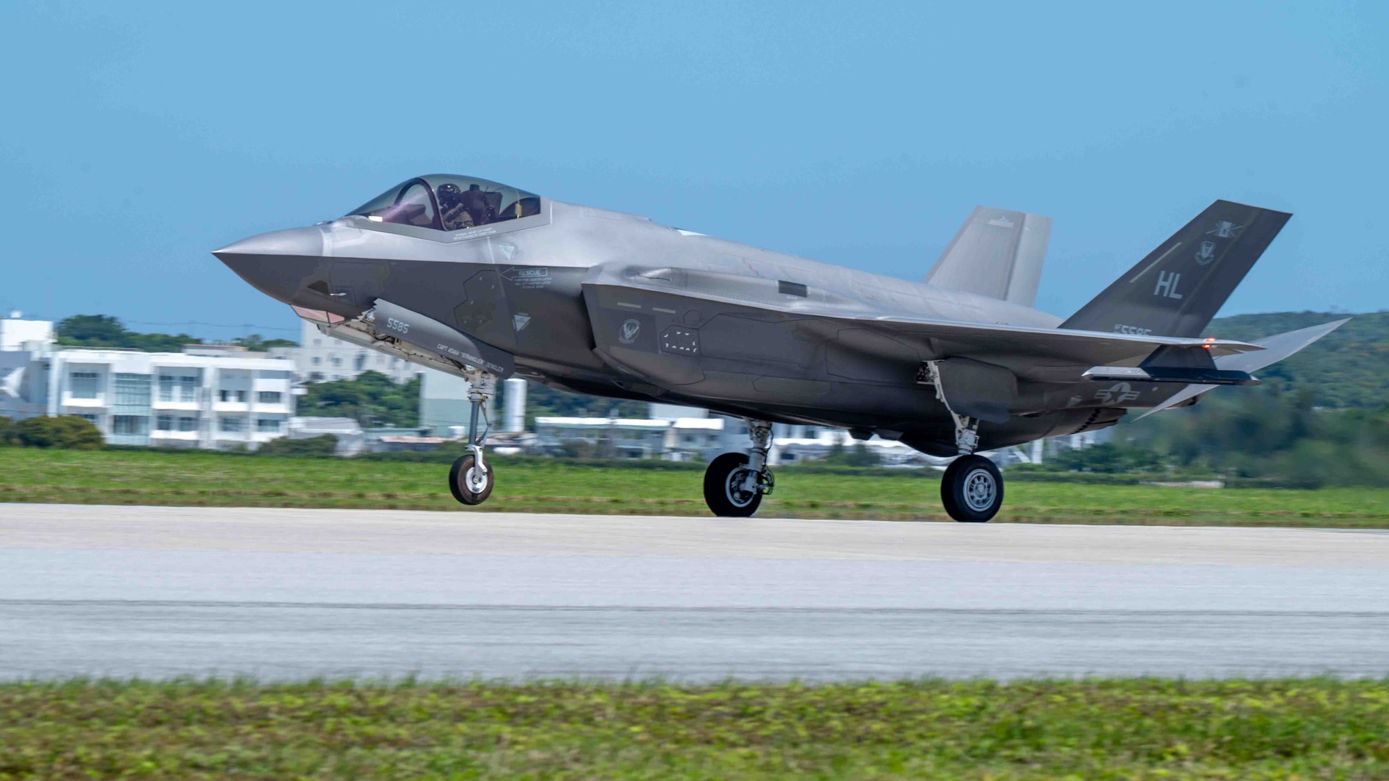 An aircraft lands on the flight line.