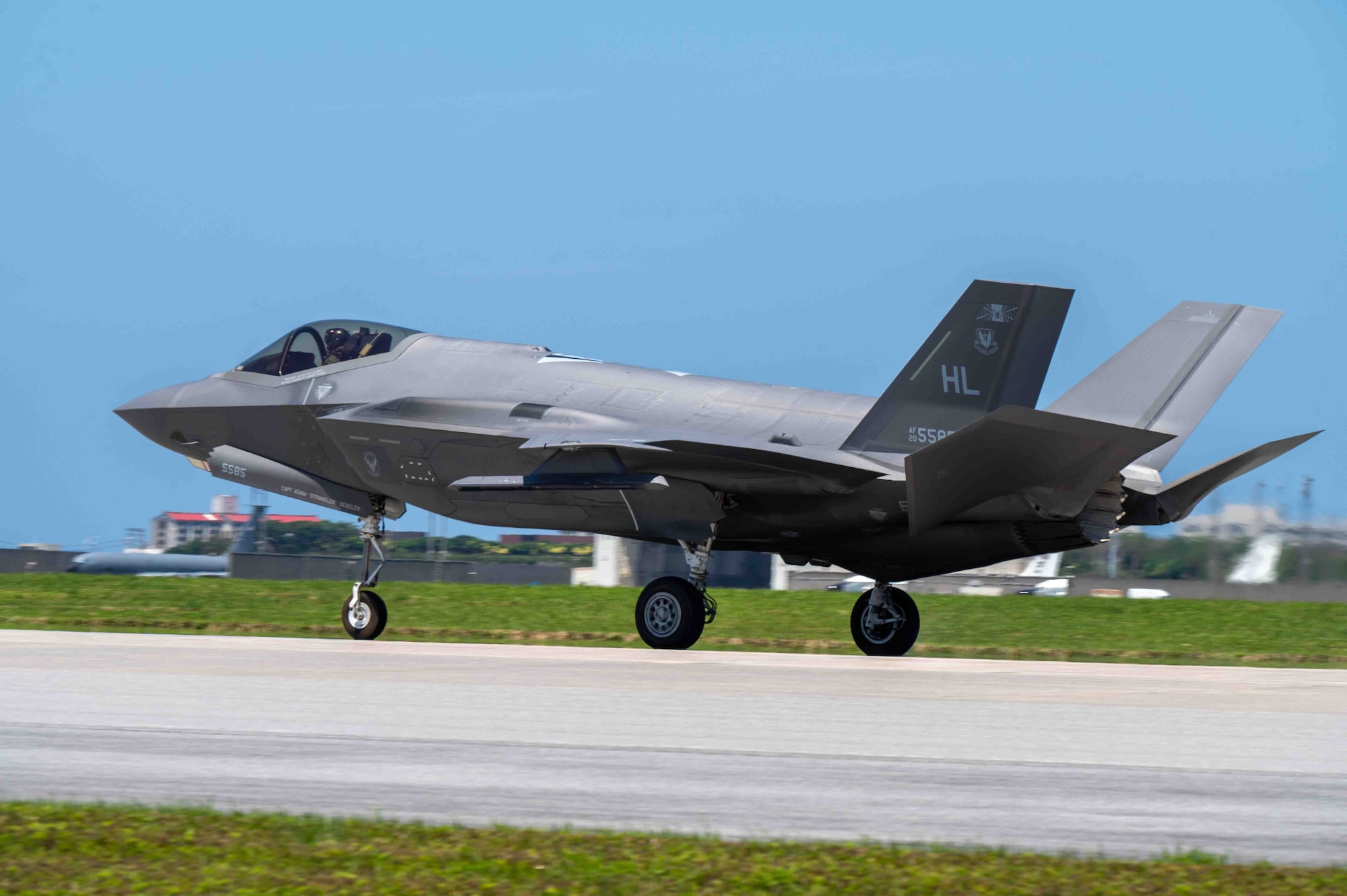 An aircraft lands on the flight line.