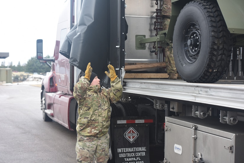 Vermont National Guard load vehicles and equipment