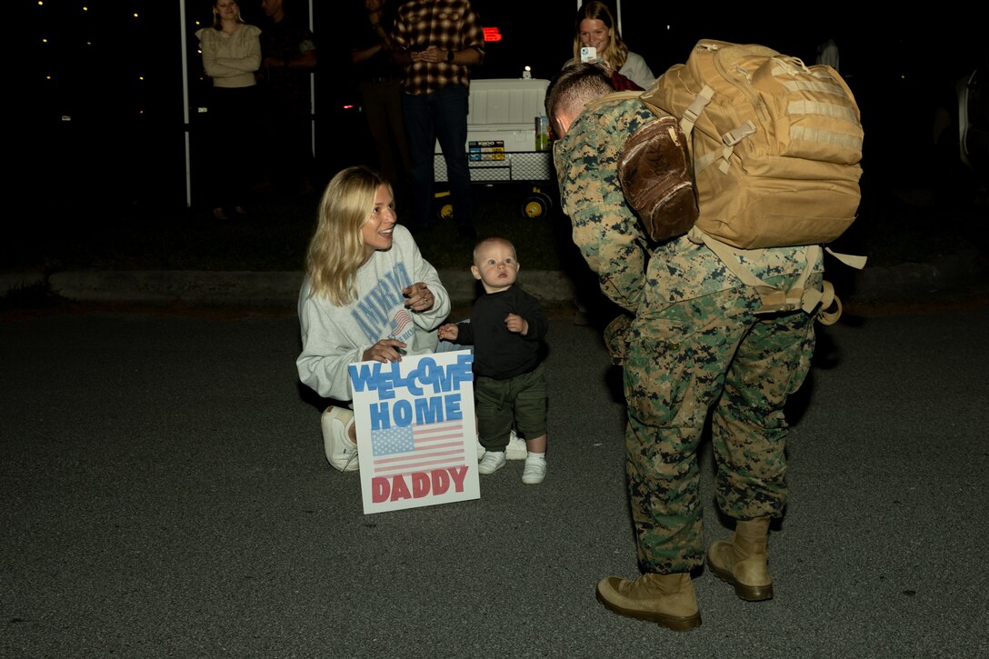 A U.S. Marine with 2d Battalion, 10th Regiment, 2d Marine Division is welcomed home by his family during a deployment homecoming on Camp Lejeune, North Carolina, April 18, 2025. 2/10 returned to Camp Lejeune from a six-month Unit Deployment Program in Okinawa. (U.S. Marine Corps photo by Cpl. Cassidy Shepherd)