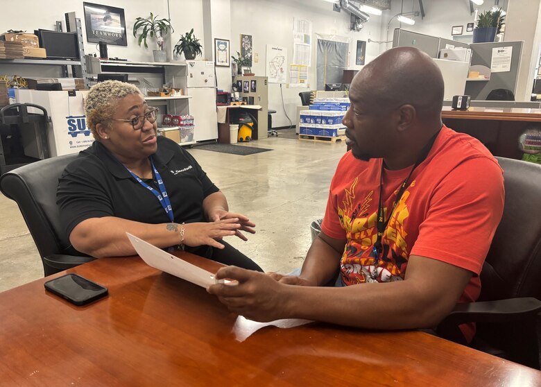 Daron Liles, USACE Savannah District facilities specialist, discusses the floor maintenance schedule for the Juliette Gordon Low Federal Building with Eurhonda McNeil, program manager for Goodwill at the U.S. Army Corps of Engineers Savannah District.