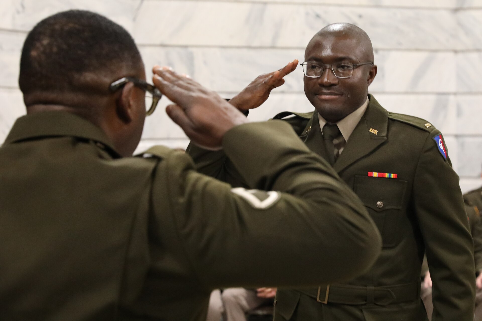U.S. Army 2nd Lt. Ibukum Oyedotun was rendered his first salute by Spc. Franklin Ejefobihi at the Capitol Rotunda in Frankfort, Kentucky, on April 12, 2025.