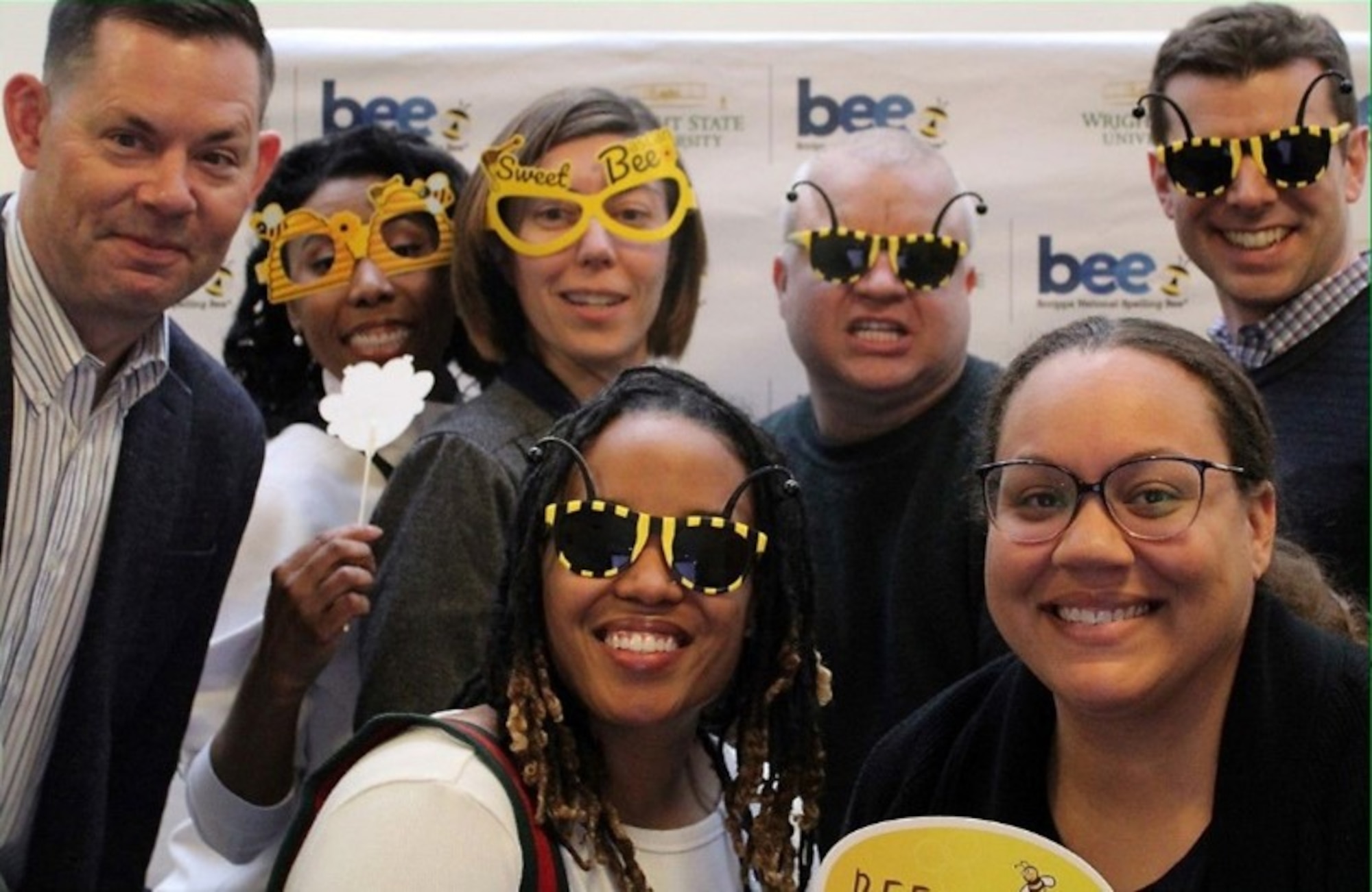 From left to right, Tech. Sgt. Ballein, Lt. Col. Autry, Lt. Col. Bishop, Tech. Sgt. Gregg, Maj. Fitzpatrick, Mrs. Hedgcorth and Lt. Col. McKinstry pose for a fun photo at the Regional Spelling Bee hosted by Wright State University March 7, 2025. Members of the 655th Intelligence, Surveillance, and Reconnaissance (ISR) Wing and subordinate local squadrons volunteered at the event.