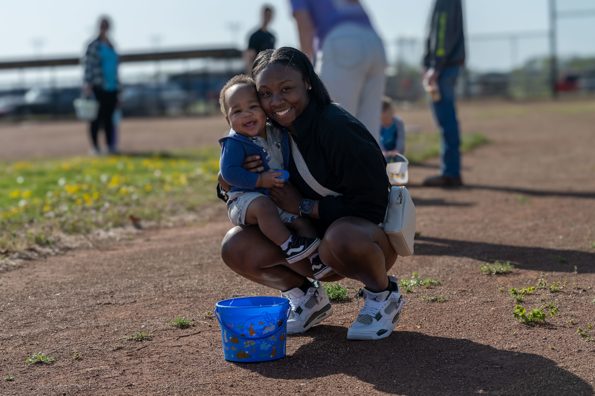 Senior Airman Grace Tindal, 22nd Force Support Squadron unit deployment manager, poses for a photo with her son at the Family Festival of Fun at McConnell Air Force Base, Kansas, April 14, 2025. The Festival of Fun is an annual event hosted by the 22nd FSS in honor of Month of the Military Child. (U.S. Air Force photo by Airman 1st Class Paula Arce)