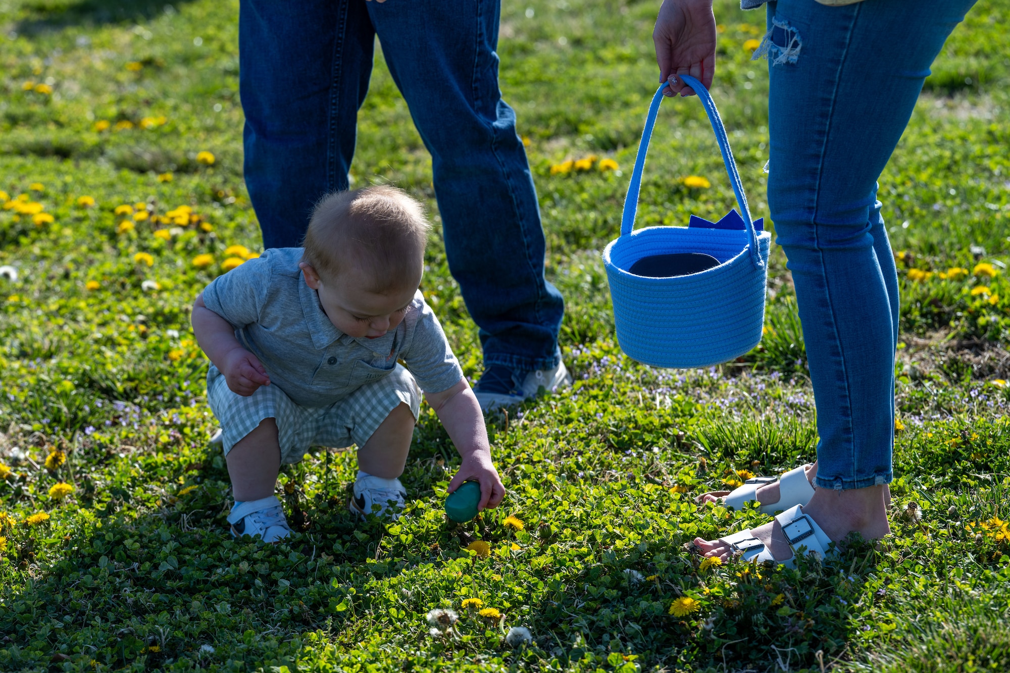 A McConnell family participates in an egg hunt during the Family Festival of Fun at McConnell Air Force Base, Kansas, April 12, 2025. Children and families enjoyed games and activities such as corn hole, egg hunts and pony rides to celebrate the Month of the Military Child. (U.S. Air Force photo by Airman 1st Class Paula Arce)