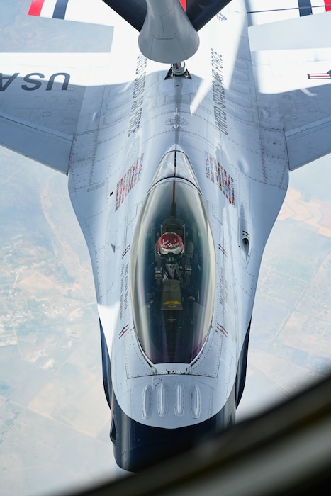 A U.S. Air Force F-16 Fighting Falcon aircraft assigned to the Thunderbirds aerial demonstration team receives fuel from a KC-135 Stratotanker aircraft assigned to the 54th Air Refueling Squadron over Texas, April 17, 2025. Capable of reaching speeds more than 1,500 miles per hour, the F-16 relies on aerial refueling to extend its range during long-distance flights. (U.S. Air Force photo by Airman 1st Class Jonah Bliss)