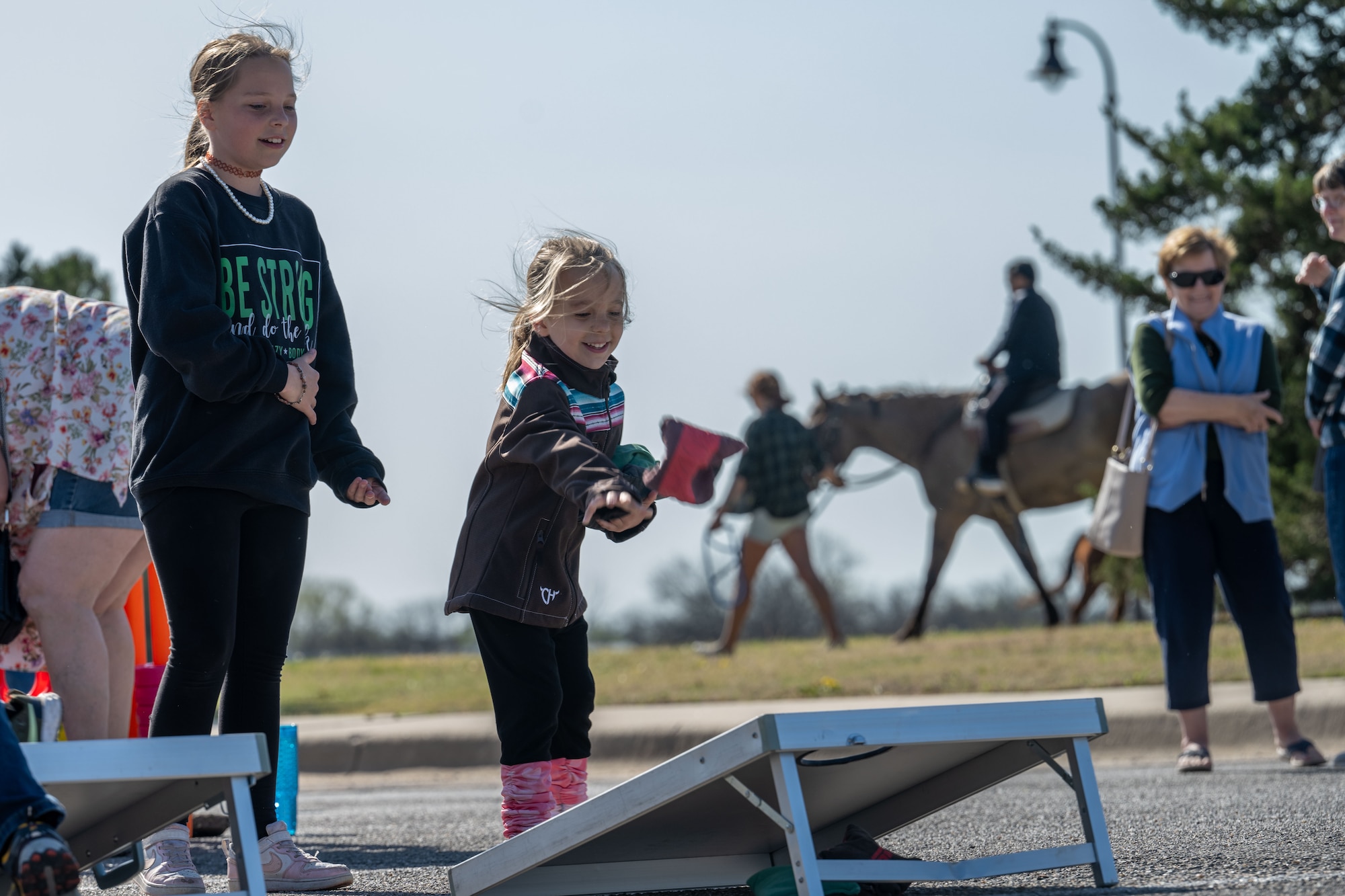 Team McConnell kids participate in a game of corn hole during the Family Festival of Fun at McConnell Air Force Base, Kansas, April 12, 2025. Children and families enjoyed games and activities such as corn hole, egg hunts and pony rides to celebrate the Month of the Military Child. (U.S. Air Force photo by Airman 1st Class Paula Arce)
