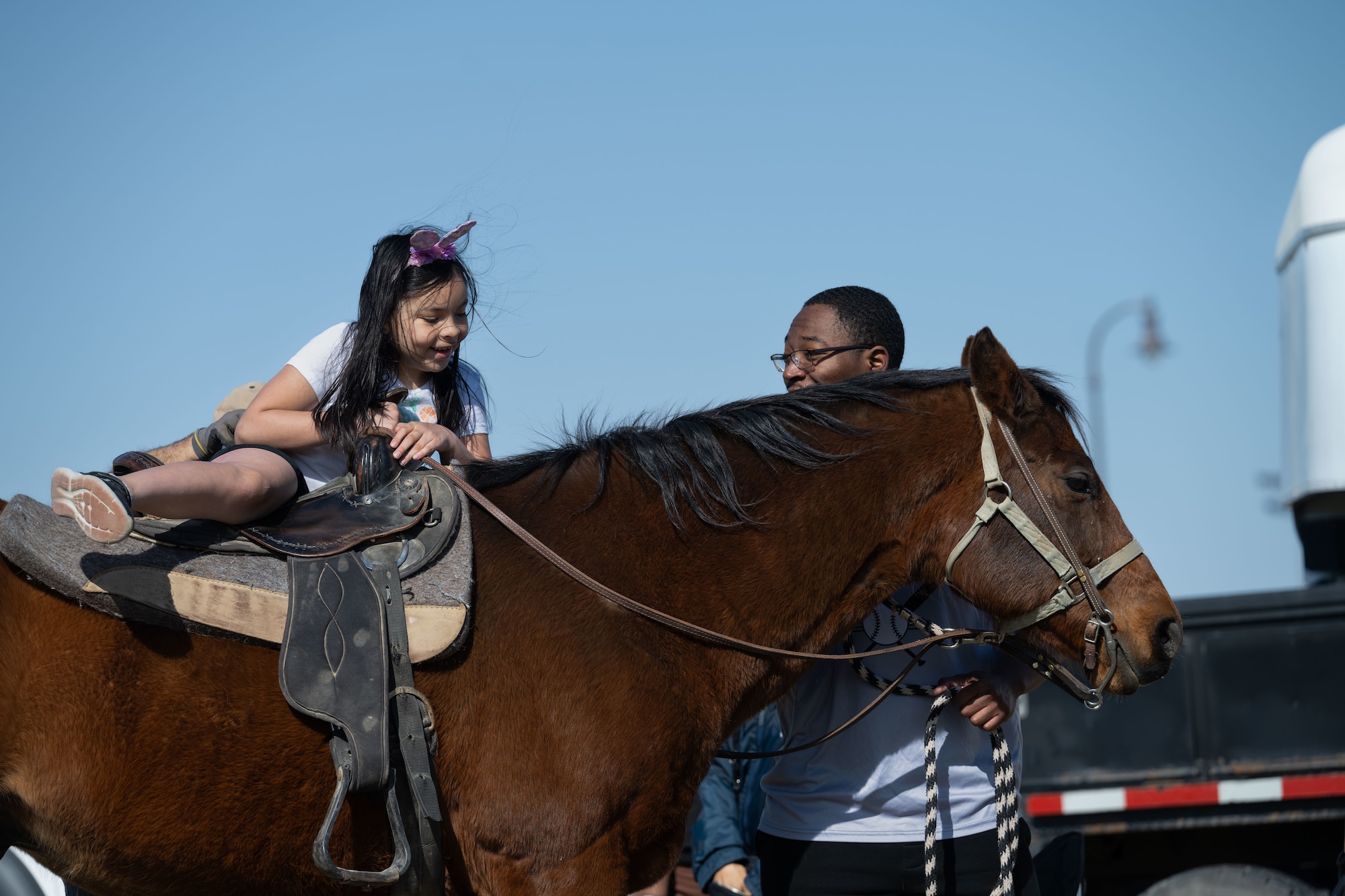 A McConnell child member mounts a horse during the Family Festival of Fun at McConnell Air Force Base, Kansas, April 12, 2025. Children and families enjoyed games and activities such as corn hole, egg hunts and pony rides. (U.S. Air Force photo by Airman 1st Class Paula Arce)
