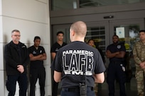 Back of paramedic as he briefs Wilford Hall Emergency Department staff