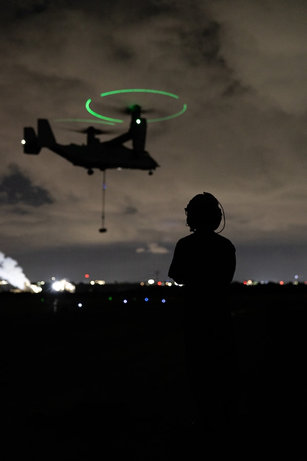 U.S. Marine Corps Sgt. Nathan Seward, a Delaware native and a landing support specialist with Combat Logistics Battalion 5, Combat Logistics Regiment 1, 1st Marine Logistics Group, observes a MV-22B Osprey aircraft during helicopter support team operations on Marine Corps Air Station Miramar, California, April 17, 2025. HST training enables rapid and efficient resupply in remote or challenging environments and helps landing support specialists and pilots familiarize themselves with insertions and extractions of heavy loads to increase their proficiency in combat scenarios. (U.S. Marine Corps photo by Lance Cpl. Desiree Ruiz)
