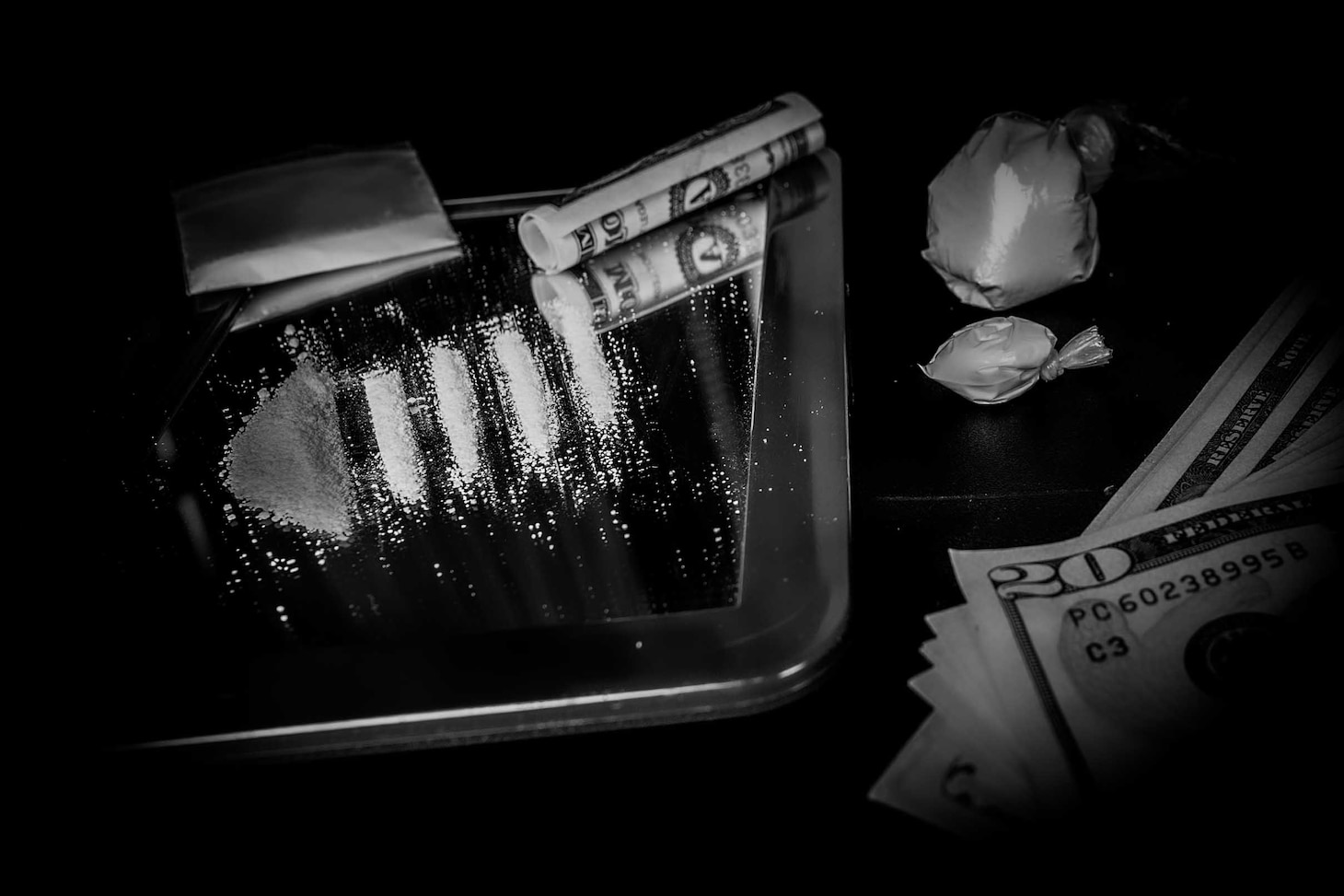 Cocaine drugs and money laid out on a mirror.