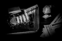 Cocaine drugs and money laid out on a mirror.