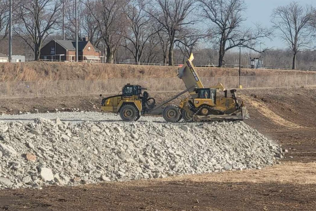 Contractors for the Brandon Road Interbasin Project place rock excavated from the channel of Illinois Waterway on the south side of the Brandon Road Lock to build access roads for future construction access needs.