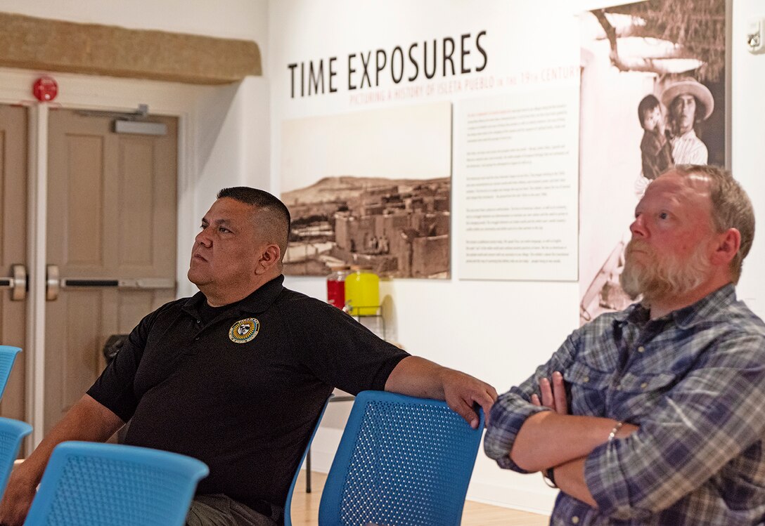 Clint Lente, left, director, Pueblo of Isleta Department of Natural Resources, and Andrew Sweetman, right, division manager, Water Resources Division, listen during the kick-off meeting for the cultural preservation study of the pueblo’s historic Pottery Mound site, April 7, 2025.