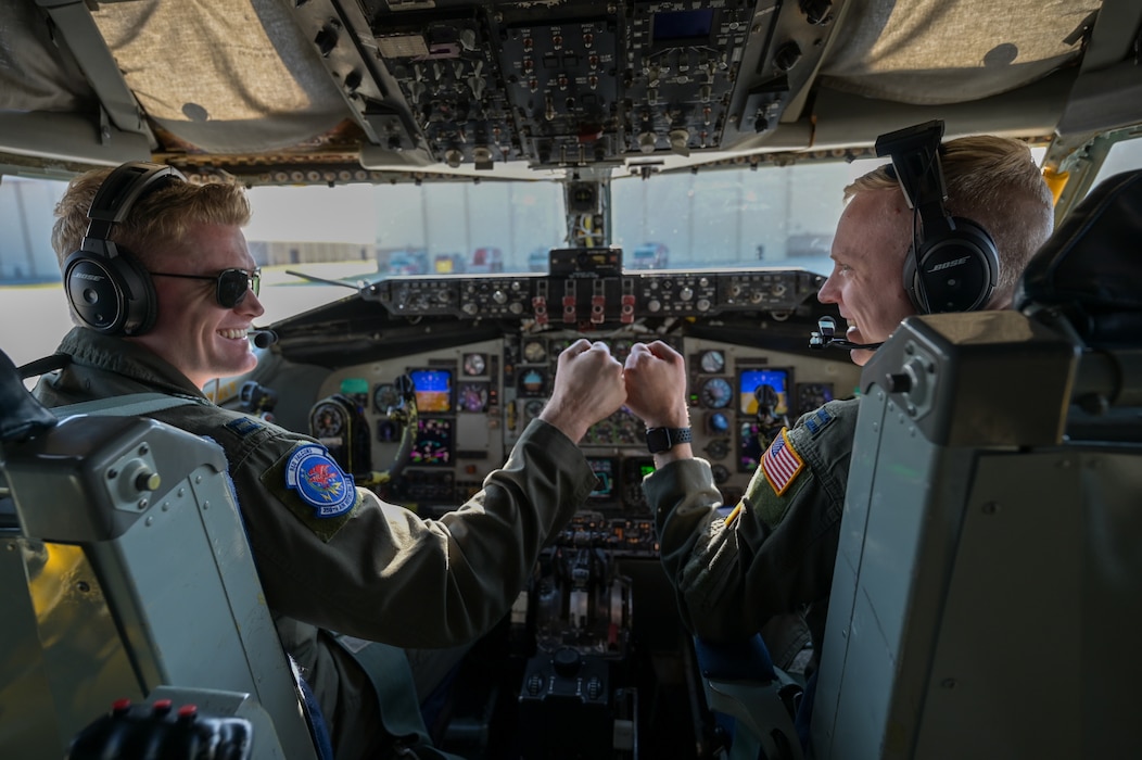 (From left) Capt. Augustus Bates and Capt. Luke Hartings, 350th Air Refueling Squadron KC-135 Stratotanker pilots, bump fists April 16, 2025, at McConnell Air Force Base, Kansas. Bates and Hartings gained tactics experience on this flight in preparation for U.S. Air Force Weapons School. (U.S. Air Force photo by Airman 1st Class Paula Arce)