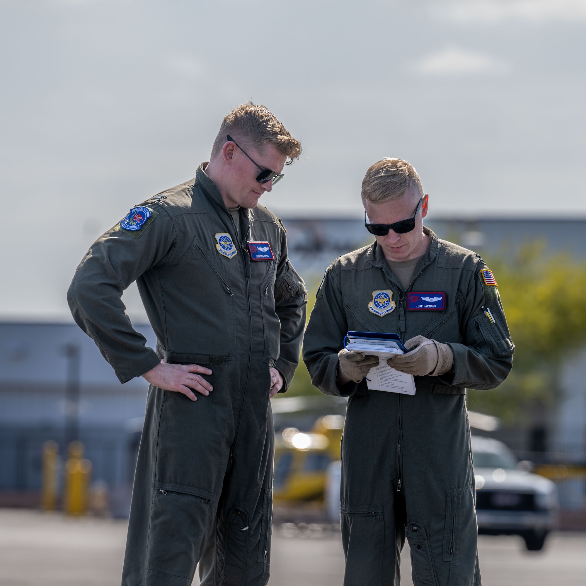 (From left) Capt. Augustus Bates and Capt. Luke Hartings, 350th Air Refueling Squadron KC-135 Stratotanker pilots, preform pre-flight duties before a low-level flight April 17, 2025, at Phoenix Sky Harbor International Airport, Arizona. Bates and Hartings gained tactics experience on the flight in preparation for U.S. Air Force Weapons Schools. (U.S. Air Force photo by Airman 1st Class Paula Arce)