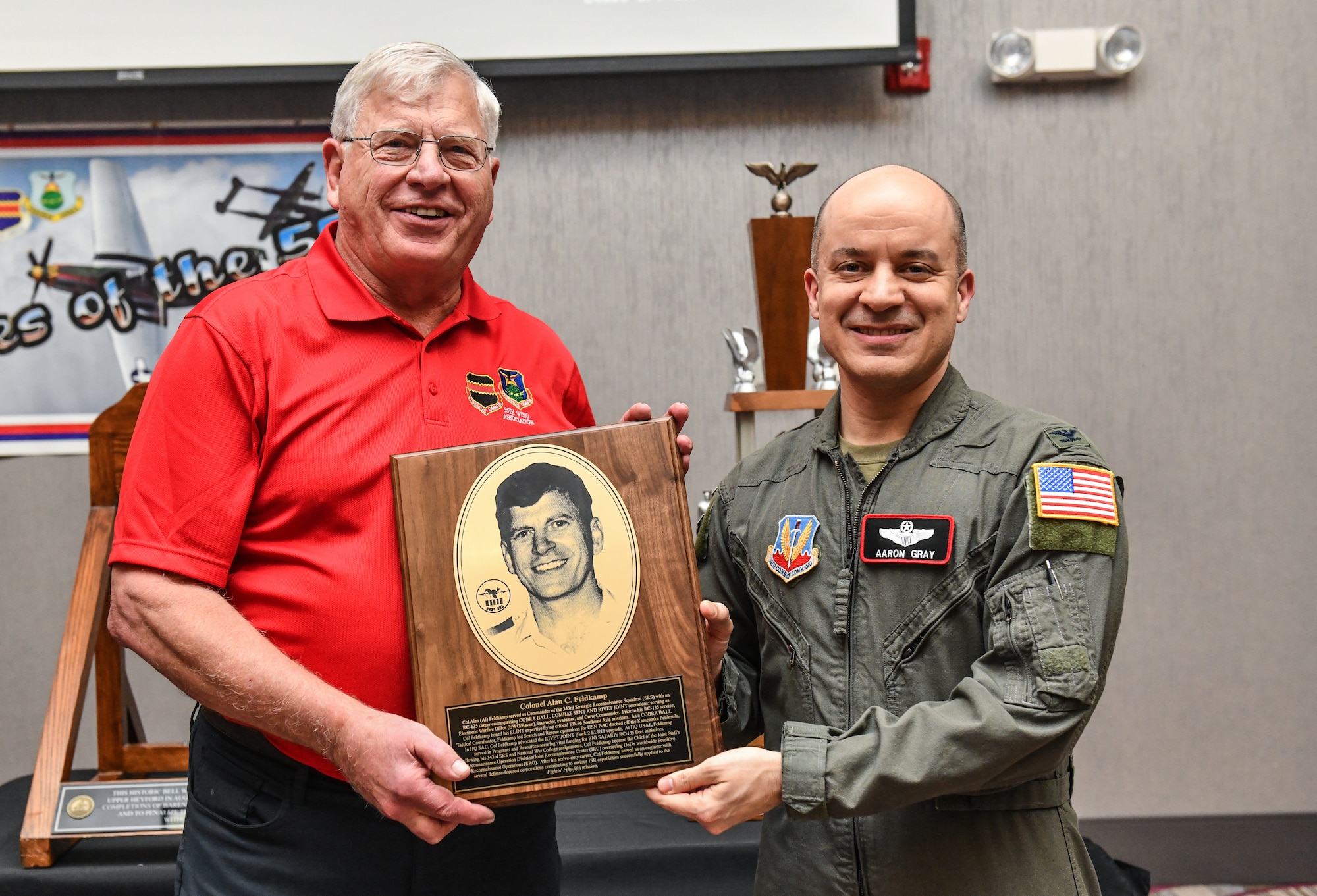 Retired Col Alan Feldkamp recieves his 55th Wing hall of fame plaque from Col. Aaron Gray, 55th Wing deputy commander, at the annual Tales of the 55th event at the Beardmore Event Center in Bellevue, Nebraska on March 27. The annual event was established in 1999 by retired Lt. Col. Robb Hoover as a way for wing veterans to share their personal experiences with former and current members. (U.S. Air Force photo by Chad Watkins)