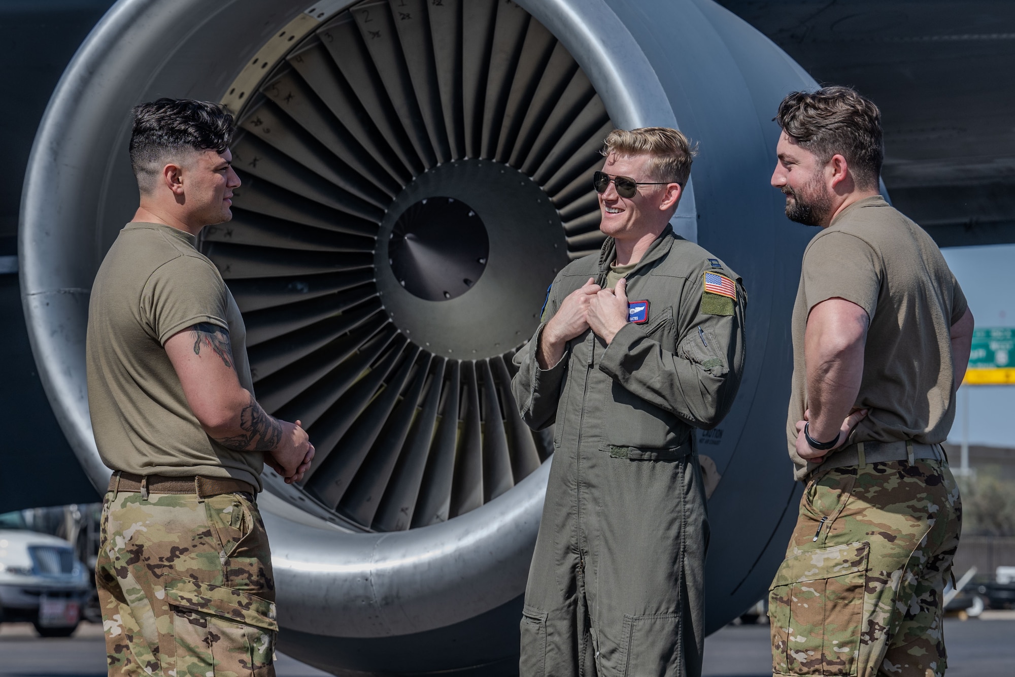 (From left) Senior Airman Ethan Ferrera 722nd Aircraft Maintenance Squadron flying crew chief (FCC), Capt. Augustus Bates, 350th Air Refueling Squadron KC-135 Stratotanker pilot, and Senior Airman Ethan Ferrera, 722nd AMXS FCC, stand in front of a KC-135 engine April 17, 2025, at Phoenix Sky Harbor International Airport, Arizona. Bates worked with the flying crew chiefs to ensure the jet was mission ready before performing a low-level flying mission over California. (U.S. Air Force photo by Airman 1st Class Paula Arce)