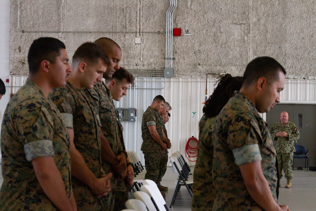U.S. Marines with Marine Transport Squadron 1 (VMR-1) pray during their 73rd Birthday Celebration on Naval Air Station (NAS) Joint Reserve Base (JRB) Fort Worth, Fort Worth, Texas, Oct. 04, 2024. The celebration was held to recognize the impact VMR-1 has had on the Fleet Marine Corps, Marine Corps Installation Command, and the Marine Corps over the past 73 years. (U.S. Marine Corps photo by Sgt. Kree Laing)