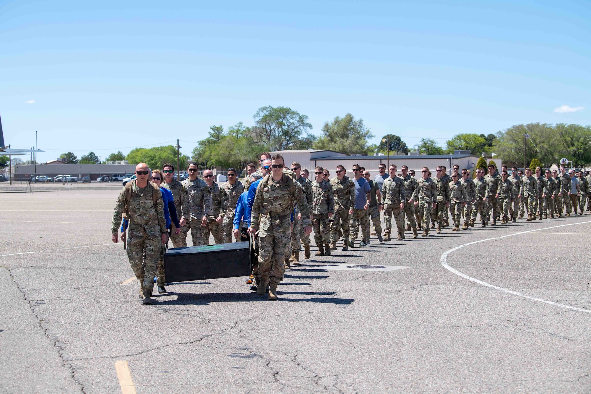 Airmen assigned to the 351st Special Warfare Training Squadron escort a memorial display honoring Capt. Joel Gentz, April 23, at Kirtland Air Force Base, N.M. The display, known as “Joel’s Box,” commemorates Gentz’s life and sacrifice after he was killed in action during a mission in Afghanistan on June 22, 2010. Led by members of the pararescue community and joined by Gentz’s family, the formation march marked the beginning of the display’s final journey to its permanent home in the Pararescue Schoolhouse’s heritage museum. (U.S. Air Force photo by Mr. Allen Winston)