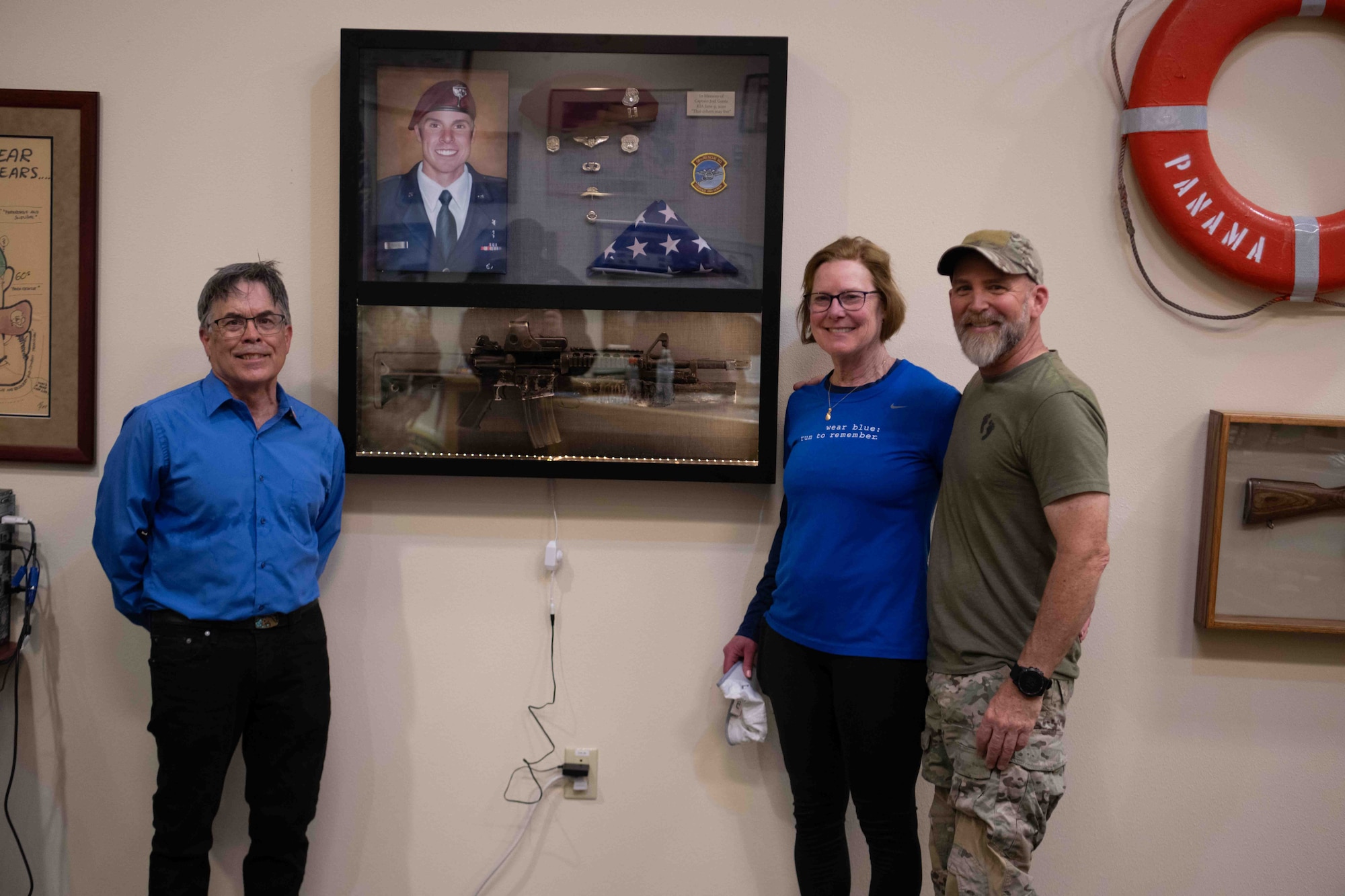 Judy Gentz, center, stands beside a memorial display honoring her son, Capt. Joel Gentz, April 23, at the Pararescue Schoolhouse’s heritage museum on Kirtland Air Force Base, N.M. The display, known as “Joel’s Box,” commemorates Capt. Gentz’s life and sacrifice after he was killed in action during a mission in Afghanistan on June 22, 2010. The memorial, surrounded by family, friends and members of the pararescue community, marks the enduring legacy of Capt. Gentz’s service and will serve as a source of inspiration for future generations of Pararescue Jumpers. (U.S. Air Force photo by Mr. Allen Winston)