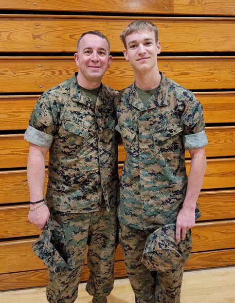 Airman 1st Class Wesley Davies (right) poses with his dad Hospital Corpsman First Class Corey Davies (left) during a Marine Corps Junior Reserve Officer Training Corps promotion ceremony. (Courtesy photo)