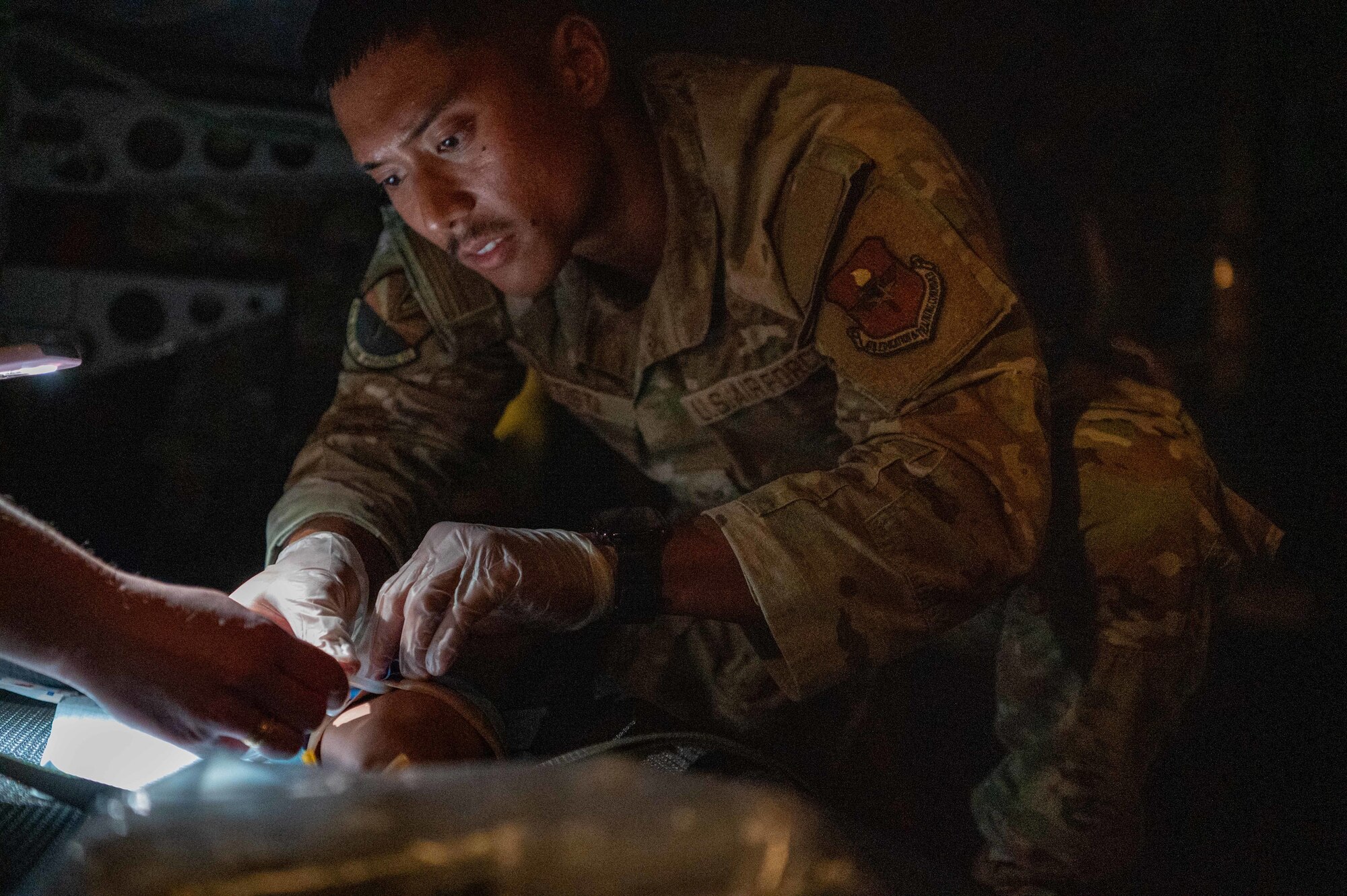 Reserve Citizen Airmen, 944th Aeromedical Staging Squadron, provide patient care during an aeromedical evacuation training event aboard a C-17 Globemaster III flying nearby Nellis Air Force Base, Nev., April 16, 2025. The training focused on patient movement, maneuvering in tight aircraft spaces, and providing medical care during flight. (U.S. Air Force photo by Staff Sgt. Alexis Orozco)