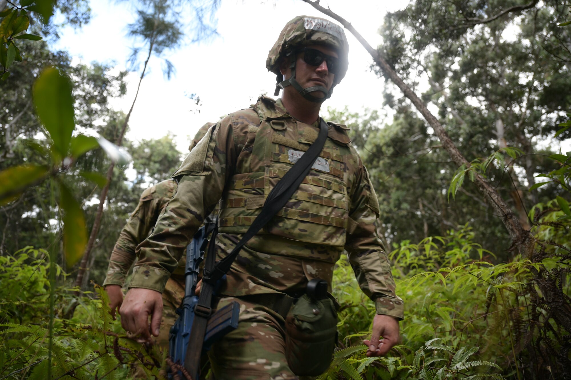 Airman treks through the forest.