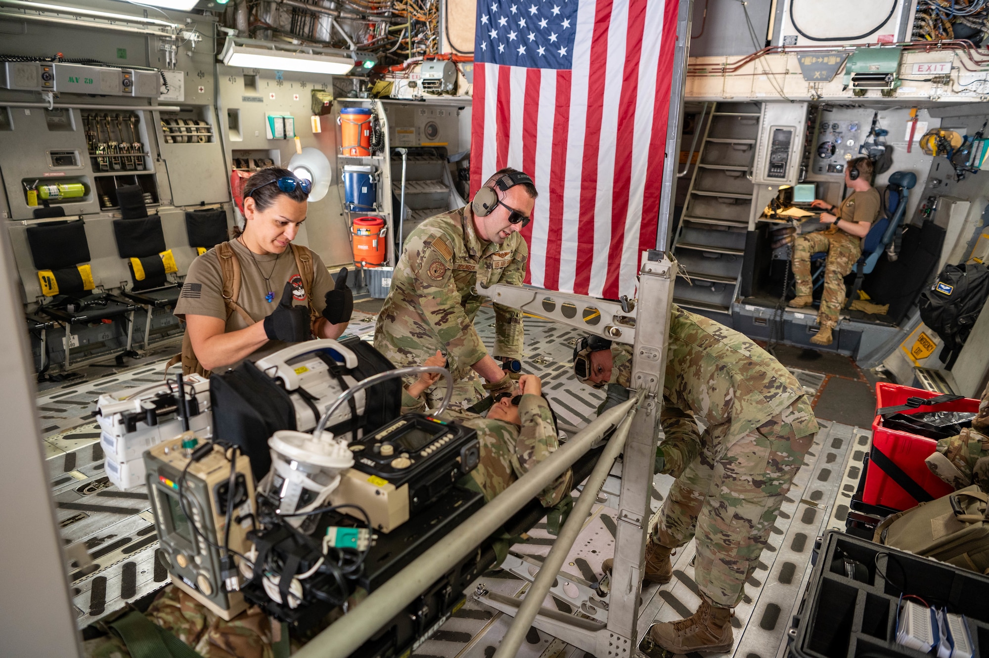 Reserve Citizen Airmen, 944th Aeromedical Staging Squadron, strap in a mock litter patient during aeromedical evacuation training event aboard a C-17 Globemaster III at Phoenix-Goodyear Airport in Goodyear Ariz., April 16, 2025. Airmen were tasked with managing non-ambulatory patients and addressing in-flight stressors such as nausea and pain while adapting to the physical effects of flying. (U.S. Air Force photo by Staff Sgt. Alexis Orozco)