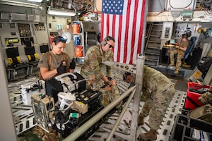 Reserve Citizen Airmen, 944th Aeromedical Staging Squadron, strap in a mock litter patient during aeromedical evacuation training event aboard a C-17 Globemaster III at Phoenix-Goodyear Airport in Goodyear Ariz., April 16, 2025. Airmen were tasked with managing non-ambulatory patients and addressing in-flight stressors such as nausea and pain while adapting to the physical effects of flying. (U.S. Air Force photo by Staff Sgt. Alexis Orozco)