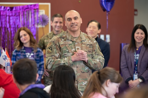 Image of Airman speaking to students.
