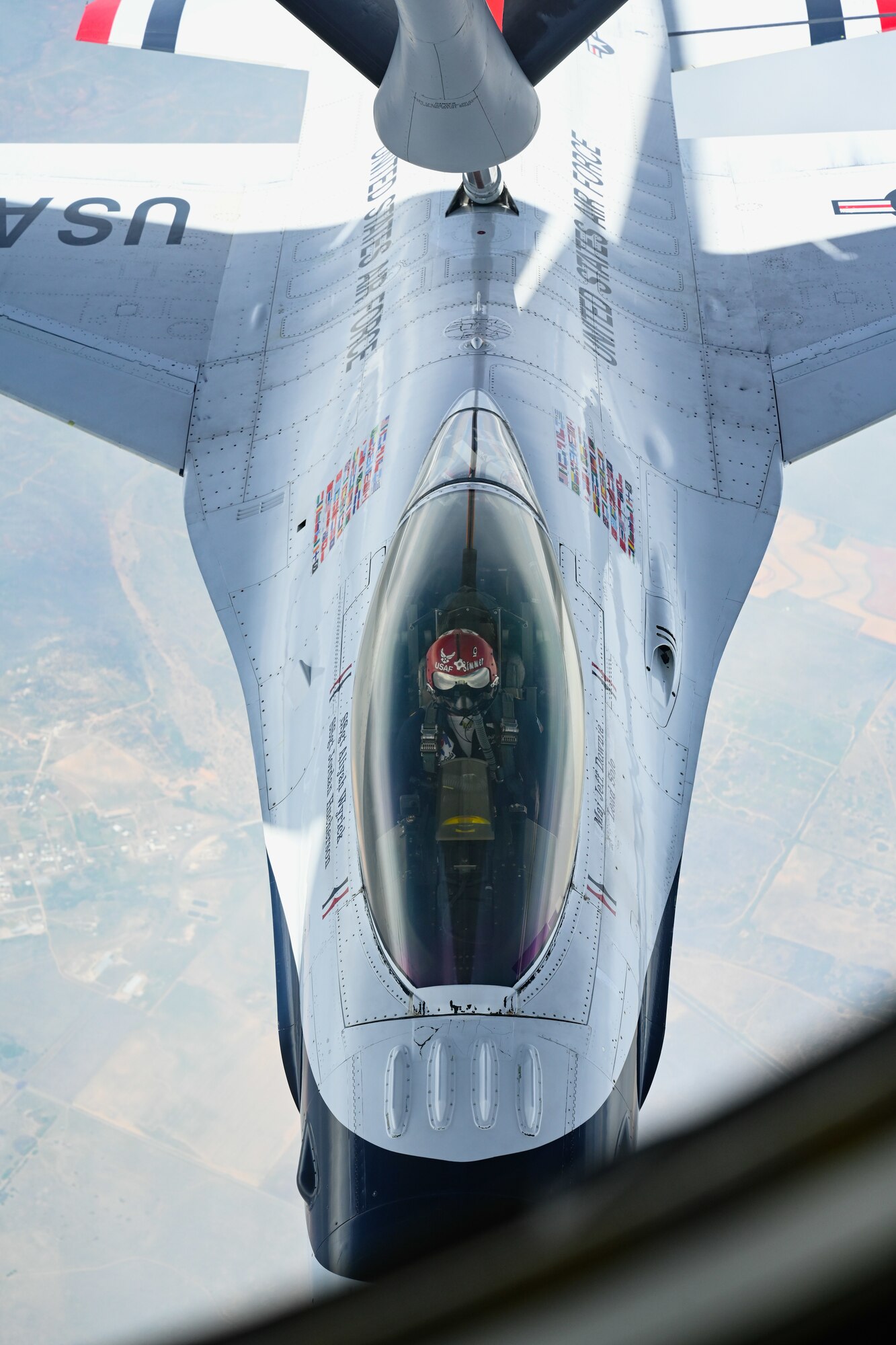 A U.S. Air Force F-16 Fighting Falcon aircraft assigned to the Thunderbirds aerial demonstration team receives fuel from a KC-135 Stratotanker aircraft assigned to the 54th Air Refueling Squadron over Texas, April 17, 2025. Capable of reaching speeds more than 1,500 miles per hour, the F-16 relies on aerial refueling to extend its range during long-distance flights. (U.S. Air Force photo by Airman 1st Class Jonah Bliss)