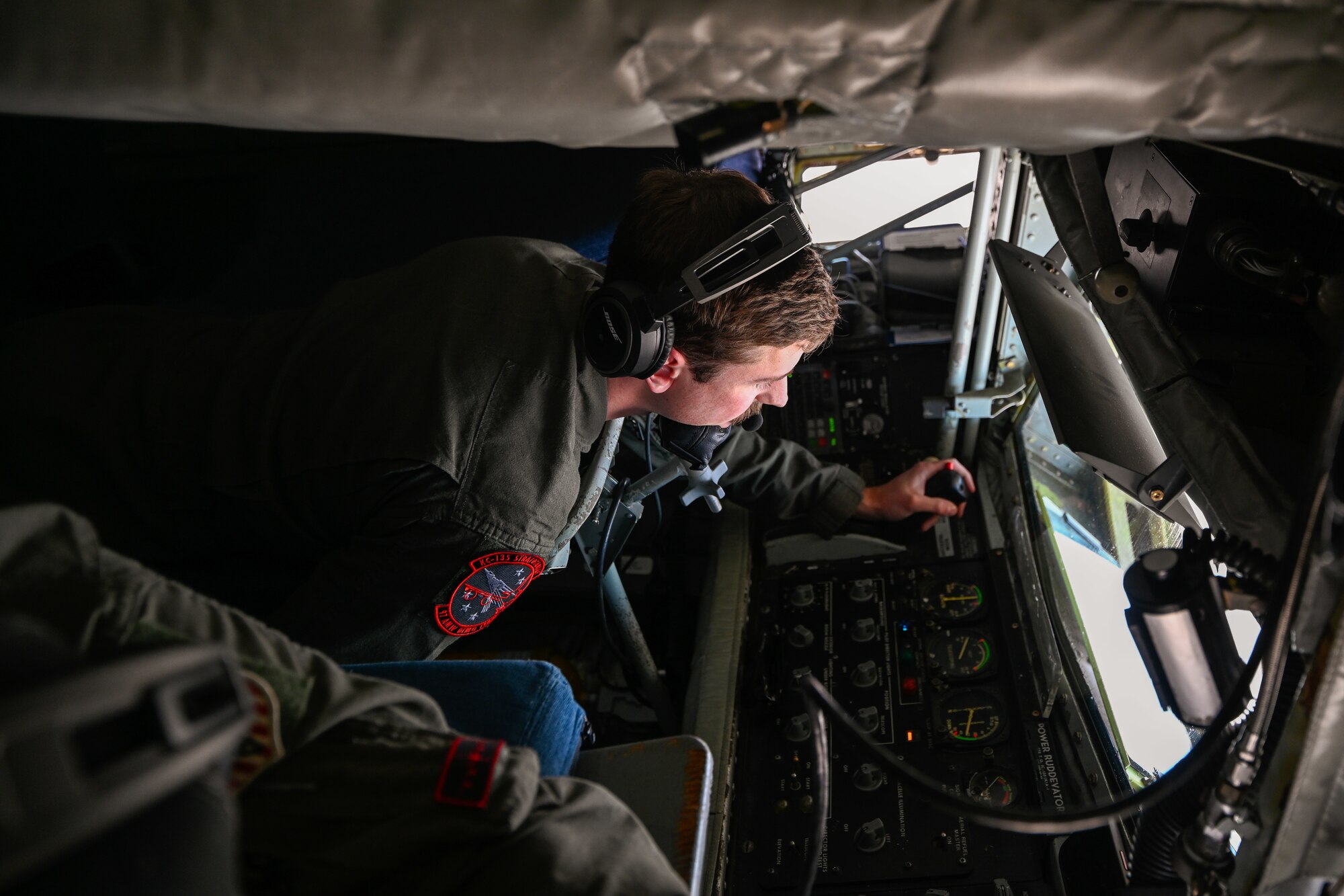 U.S. Air Force Staff Sgt. Nick Belmonte, 54th Air Refueling Squadron instructor boom operator, prepares to refuel an F-16 Fighting Falcon assigned to the Thunderbirds aerial demonstration team over Texas, April 17, 2025. Boom operators are responsible for safely guiding receiver aircraft into position to transfer fuel during flight. (U.S. Air Force photo by Airman 1st Class Jonah Bliss)